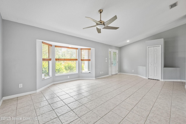 unfurnished room featuring vaulted ceiling, baseboards, visible vents, a ceiling fan, and light tile patterned floors