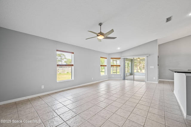unfurnished living room with light tile patterned floors, ceiling fan, baseboards, lofted ceiling, and visible vents