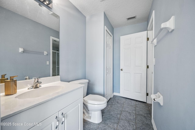 bathroom with tile patterned floors, an enclosed shower, visible vents, toilet, and vanity