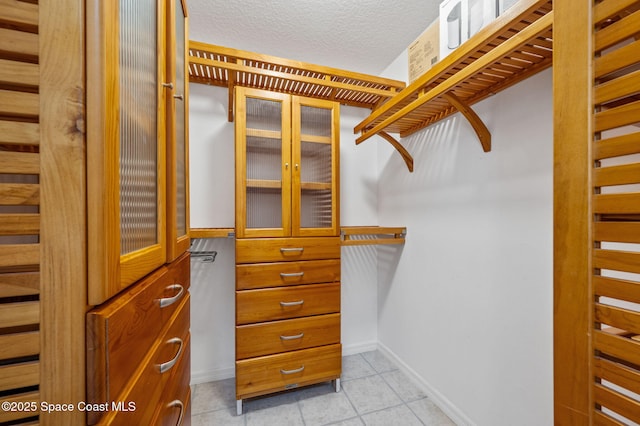 spacious closet featuring light tile patterned floors