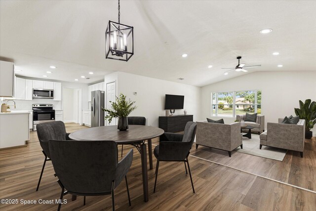 dining area featuring recessed lighting, ceiling fan, vaulted ceiling, and wood finished floors