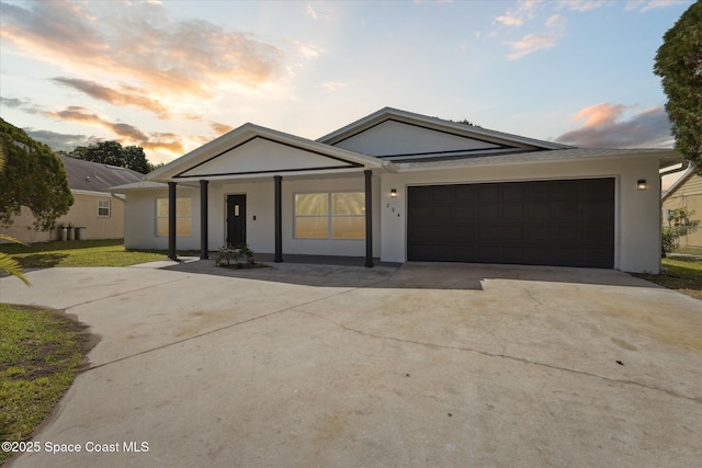 334 Emerson Dr NW, Palm Bay, FL 32907 - single story home with driveway, an attached garage, stucco siding, and covered porch
