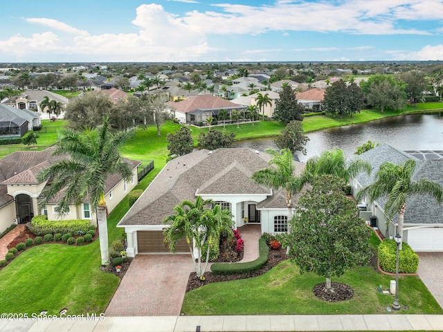 birds eye view of property with a water view and a residential view