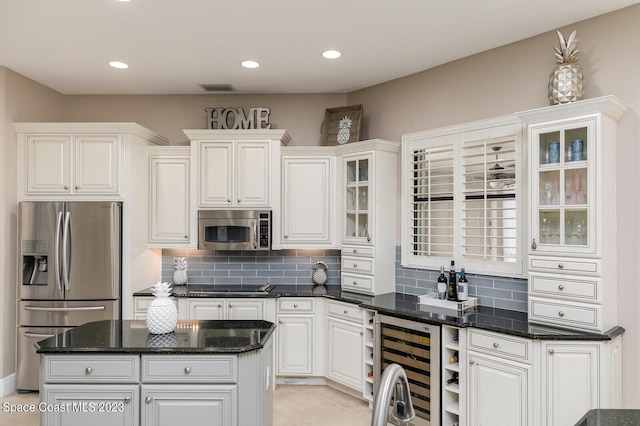 kitchen featuring tasteful backsplash, appliances with stainless steel finishes, and white cabinets