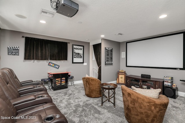 cinema featuring light carpet and a textured ceiling