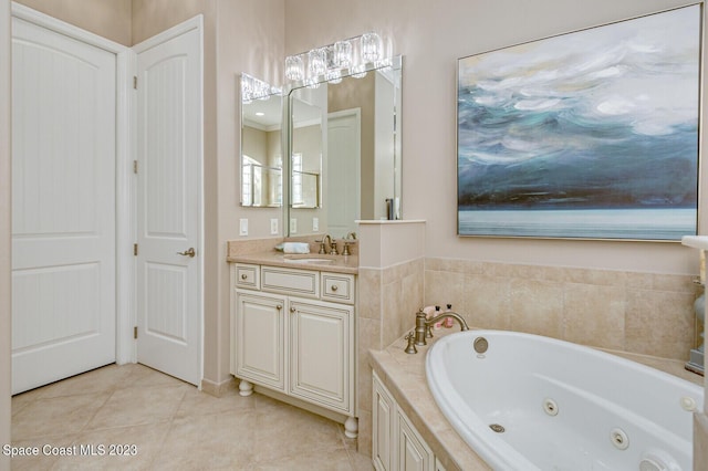 bathroom featuring tile patterned flooring, vanity, and a bathing tub