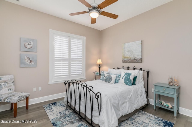 bedroom featuring dark wood-type flooring and ceiling fan