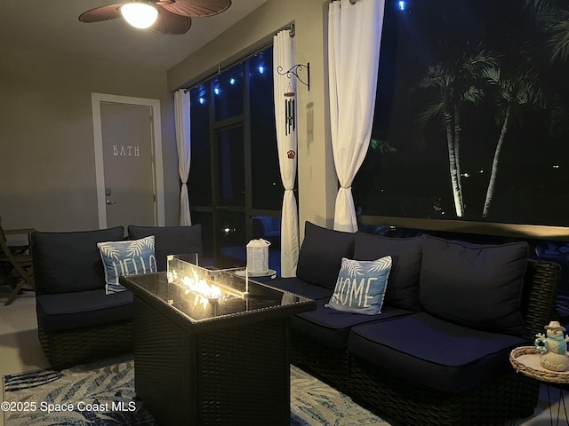 view of patio featuring ceiling fan and a fire pit