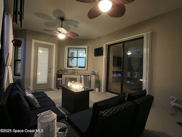 living room featuring ceiling fan and sink