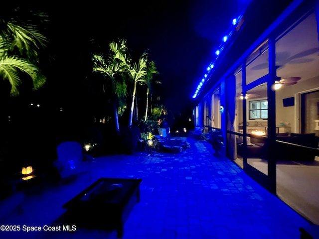 pool at twilight with ceiling fan