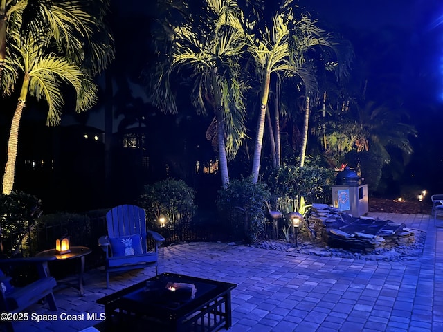 patio at night with a fire pit