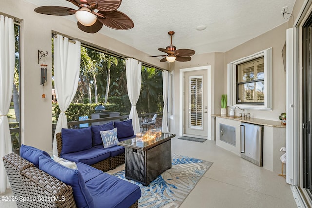 sunroom / solarium with ceiling fan and sink