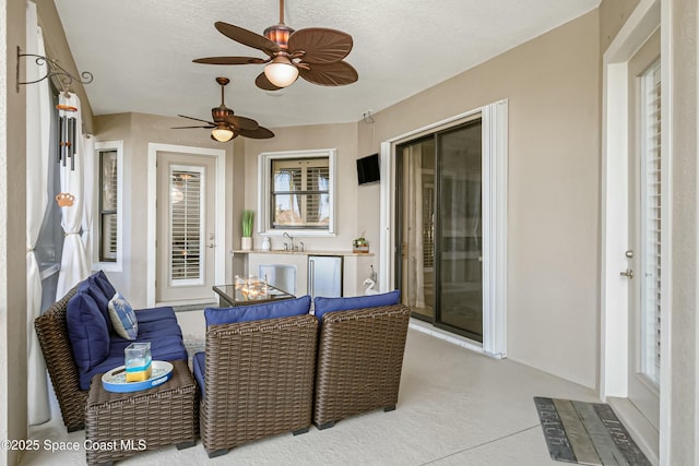 view of patio with sink and ceiling fan