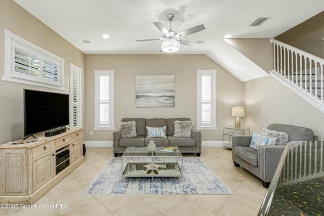 living room featuring light tile patterned floors and ceiling fan