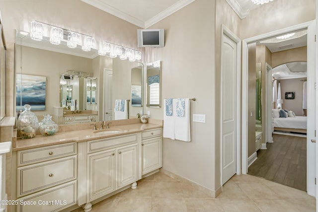 bathroom featuring crown molding, tile patterned floors, and vanity