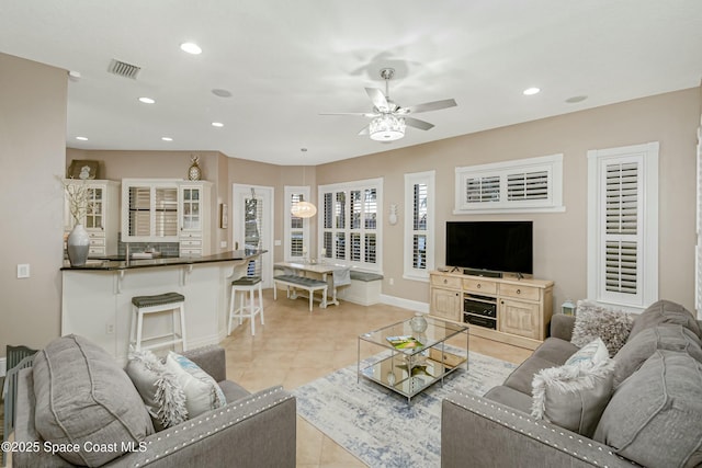 tiled living room featuring ceiling fan