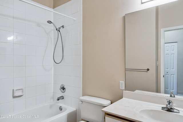 full bathroom with tiled shower / bath, vanity, and toilet