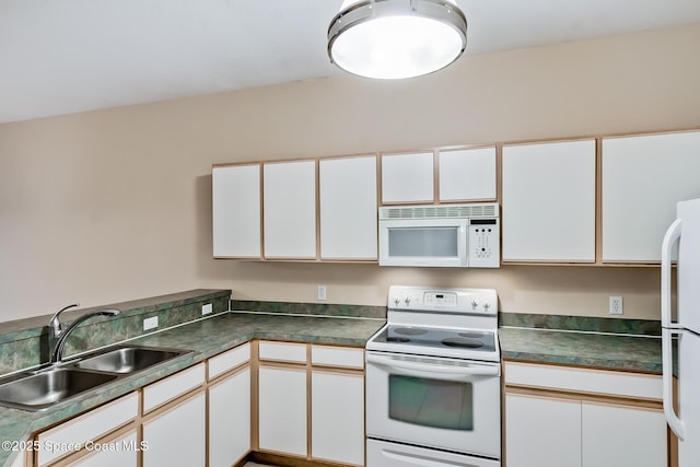 kitchen featuring white appliances, sink, and white cabinets