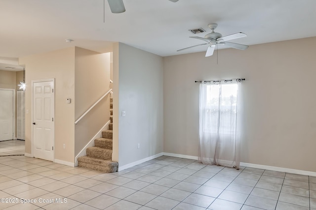 tiled empty room with ceiling fan