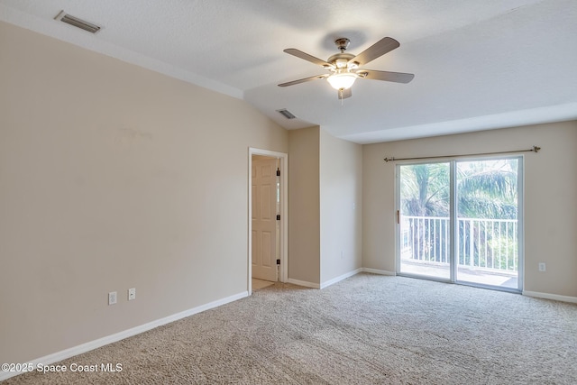 empty room featuring light carpet, lofted ceiling, and ceiling fan