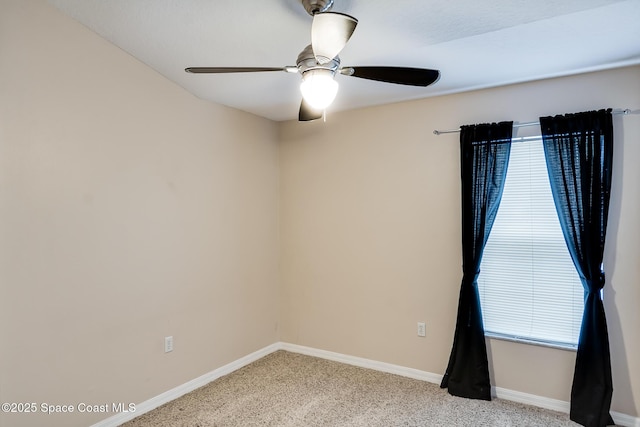 spare room with ceiling fan and light carpet