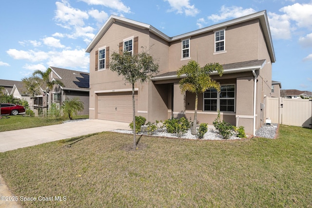 traditional-style home with a garage, a front yard, concrete driveway, and stucco siding