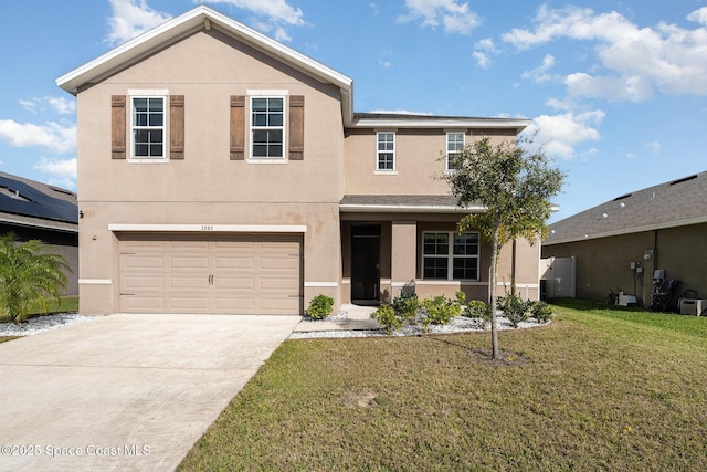 traditional home featuring an attached garage, a front lawn, concrete driveway, and stucco siding