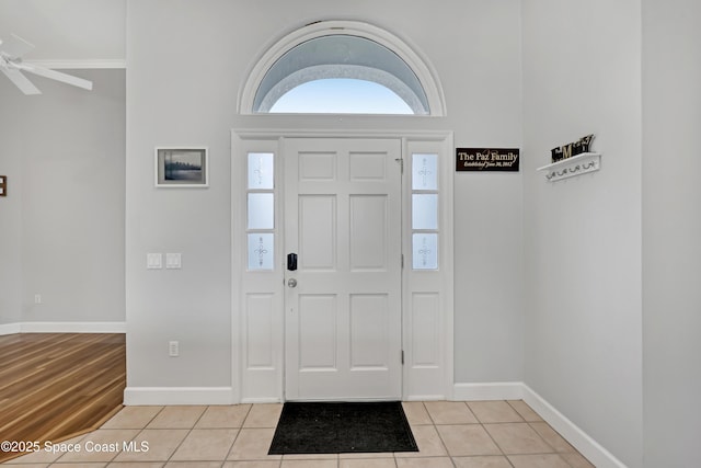 entrance foyer with light tile patterned flooring and baseboards