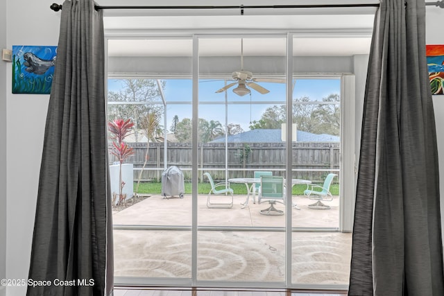 doorway to outside with a ceiling fan and a wealth of natural light