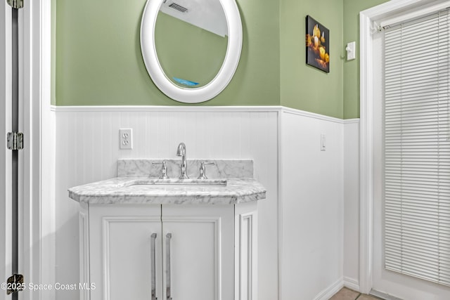 bathroom featuring wainscoting and vanity