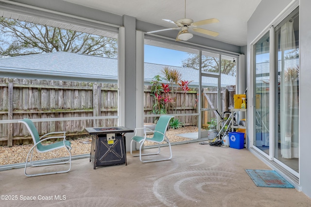 sunroom / solarium featuring ceiling fan