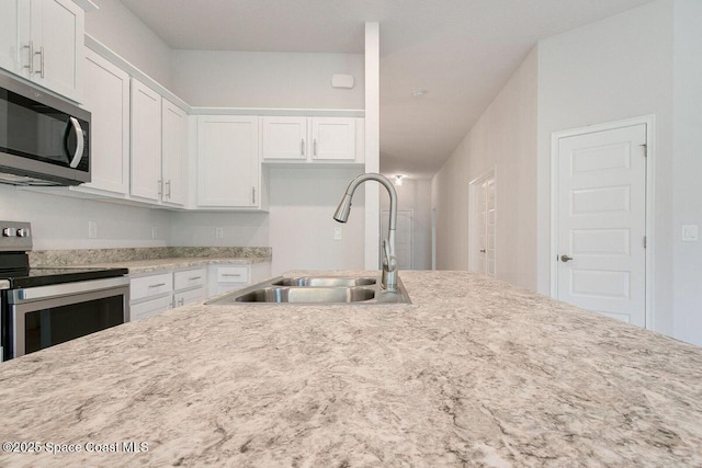 kitchen featuring sink, white cabinets, and appliances with stainless steel finishes