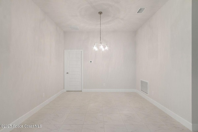 unfurnished room with an inviting chandelier