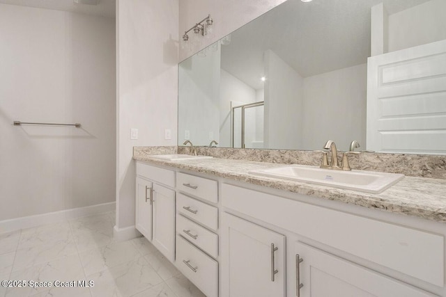 bathroom with vanity and a shower with shower door