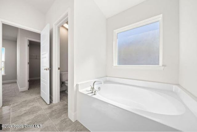 bathroom featuring a bathtub and toilet