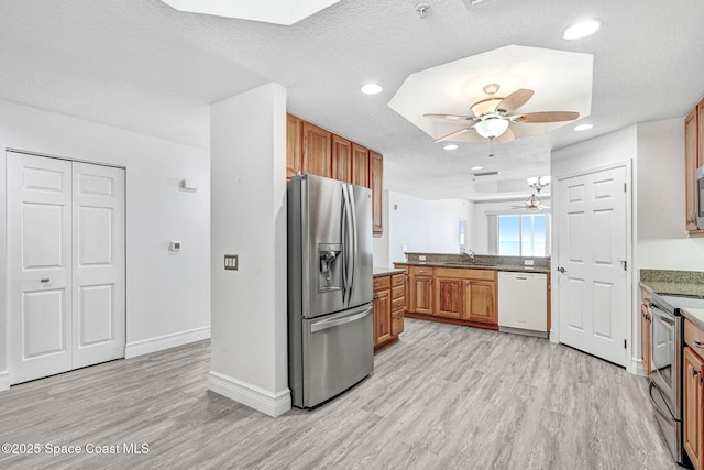 kitchen with light hardwood / wood-style flooring, sink, a textured ceiling, ceiling fan, and stainless steel appliances