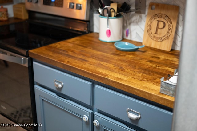 kitchen featuring butcher block counters and stainless steel electric range