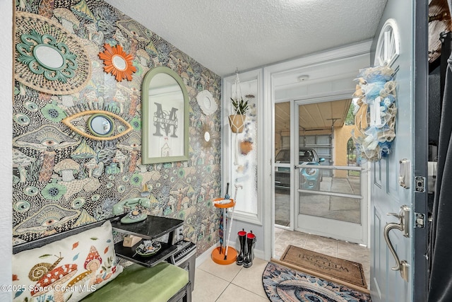 kitchen with a textured ceiling, baseboards, and wallpapered walls