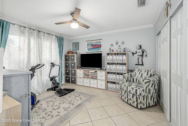 exercise room featuring a ceiling fan, visible vents, crown molding, and light tile patterned flooring