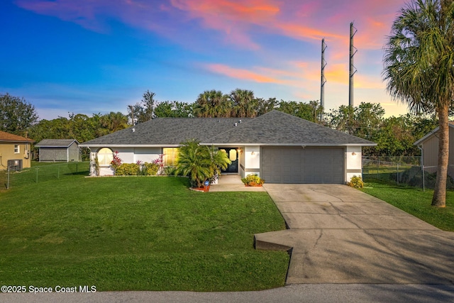 single story home featuring a yard and a garage