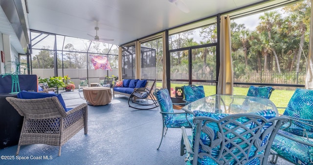 sunroom / solarium featuring ceiling fan