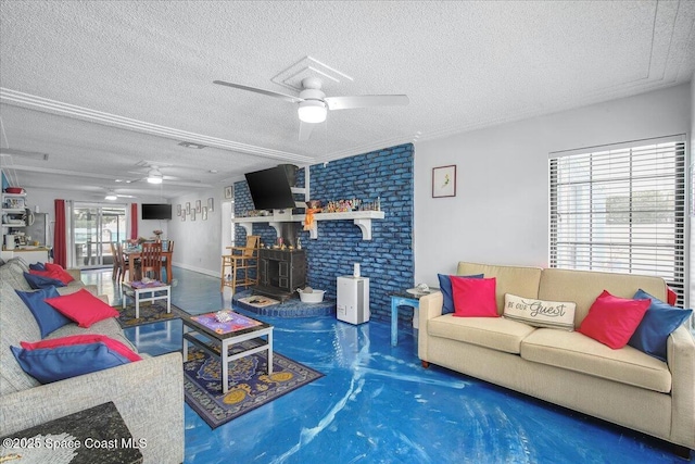 living room with a textured ceiling, carpet floors, ceiling fan, and a wood stove