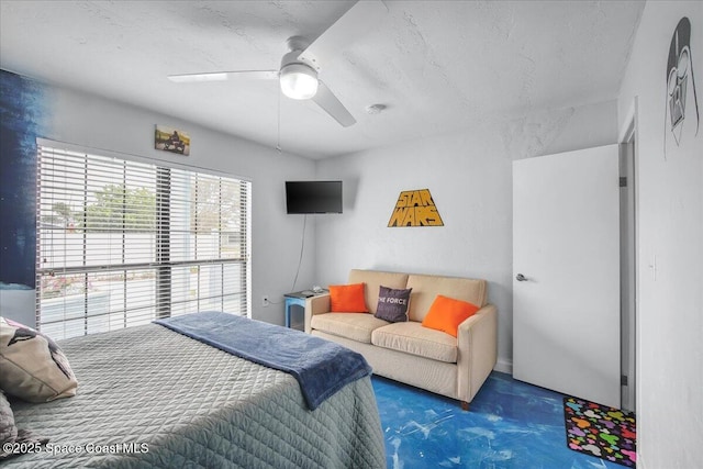 carpeted bedroom with ceiling fan and a textured ceiling