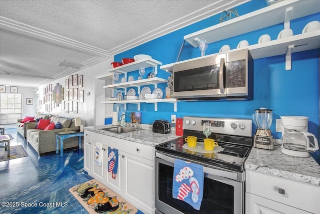 kitchen featuring sink, white cabinetry, a textured ceiling, stainless steel appliances, and light stone countertops