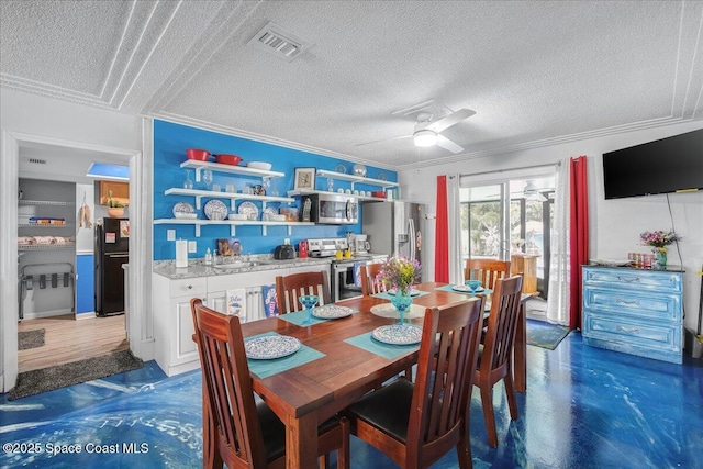 dining space with ornamental molding, sink, a textured ceiling, and ceiling fan