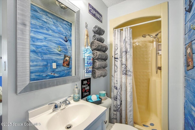 bathroom featuring vanity, toilet, and walk in shower