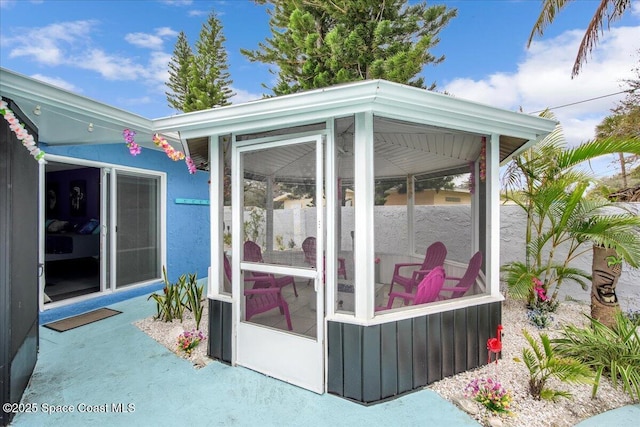 view of outdoor structure featuring a sunroom