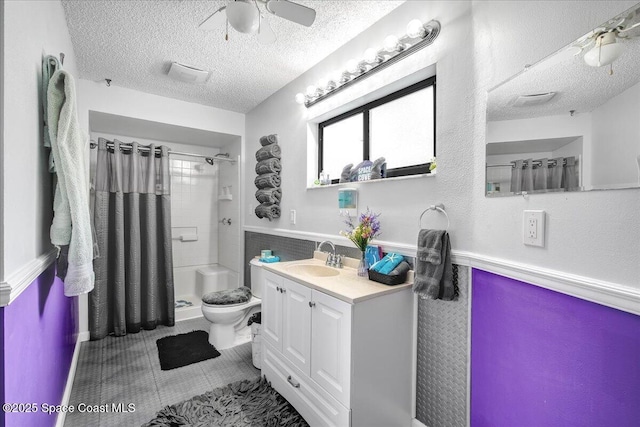 bathroom with vanity, ceiling fan, walk in shower, toilet, and a textured ceiling