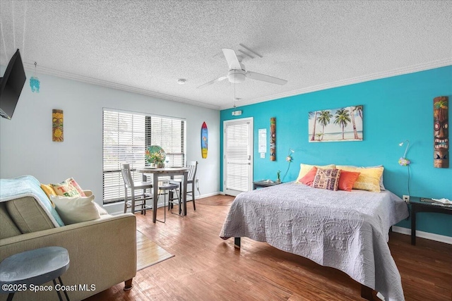 bedroom with crown molding, ceiling fan, wood-type flooring, and a textured ceiling