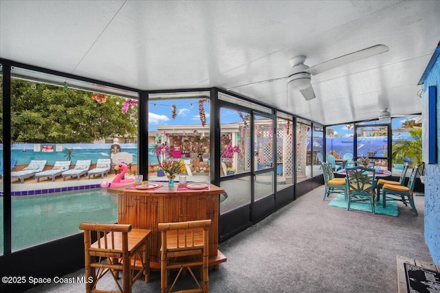 sunroom featuring ceiling fan